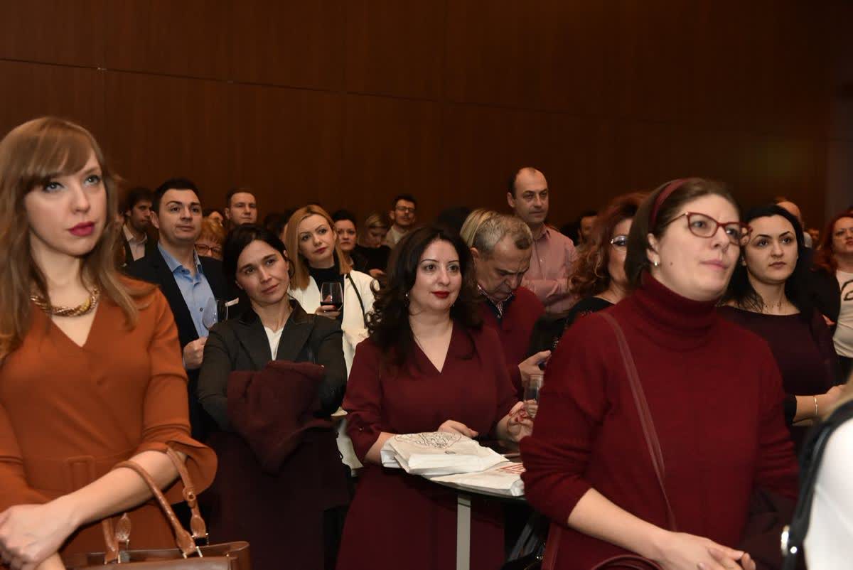 The seated audience at the Skopje launch of Будење на свеста, 2019, copies of the book in hand